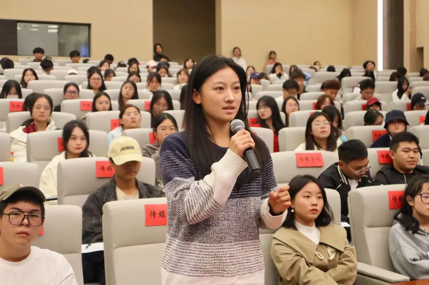 Speaking with a microphone in an auditorium